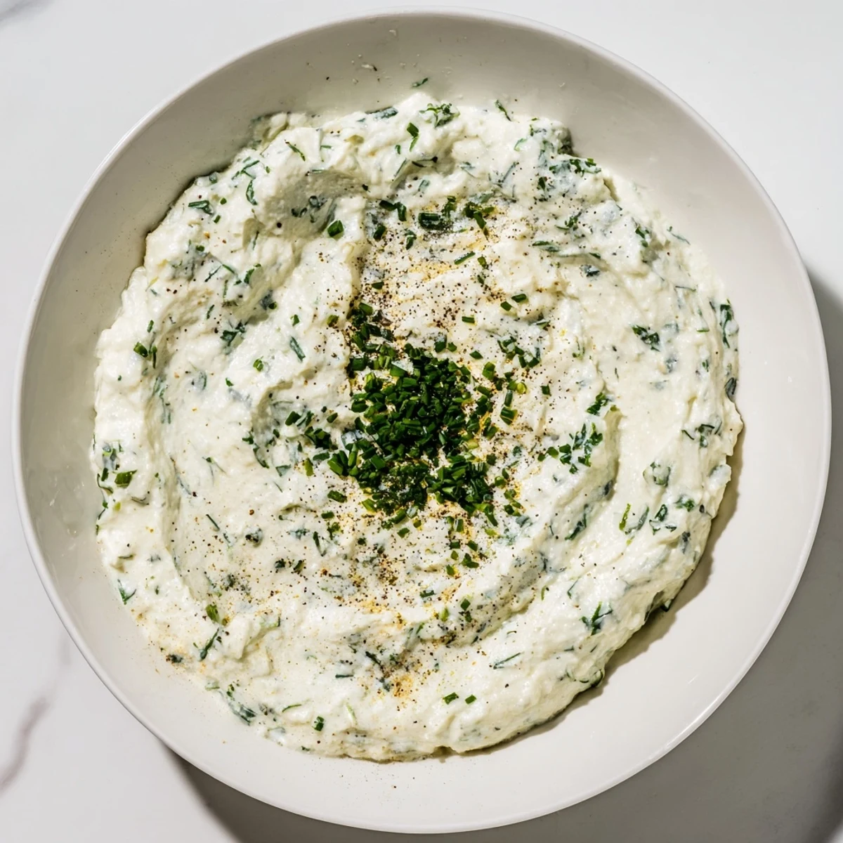 A close-up shot of creamy dip, ready to be scooped up with fresh, crunchy vegetables.