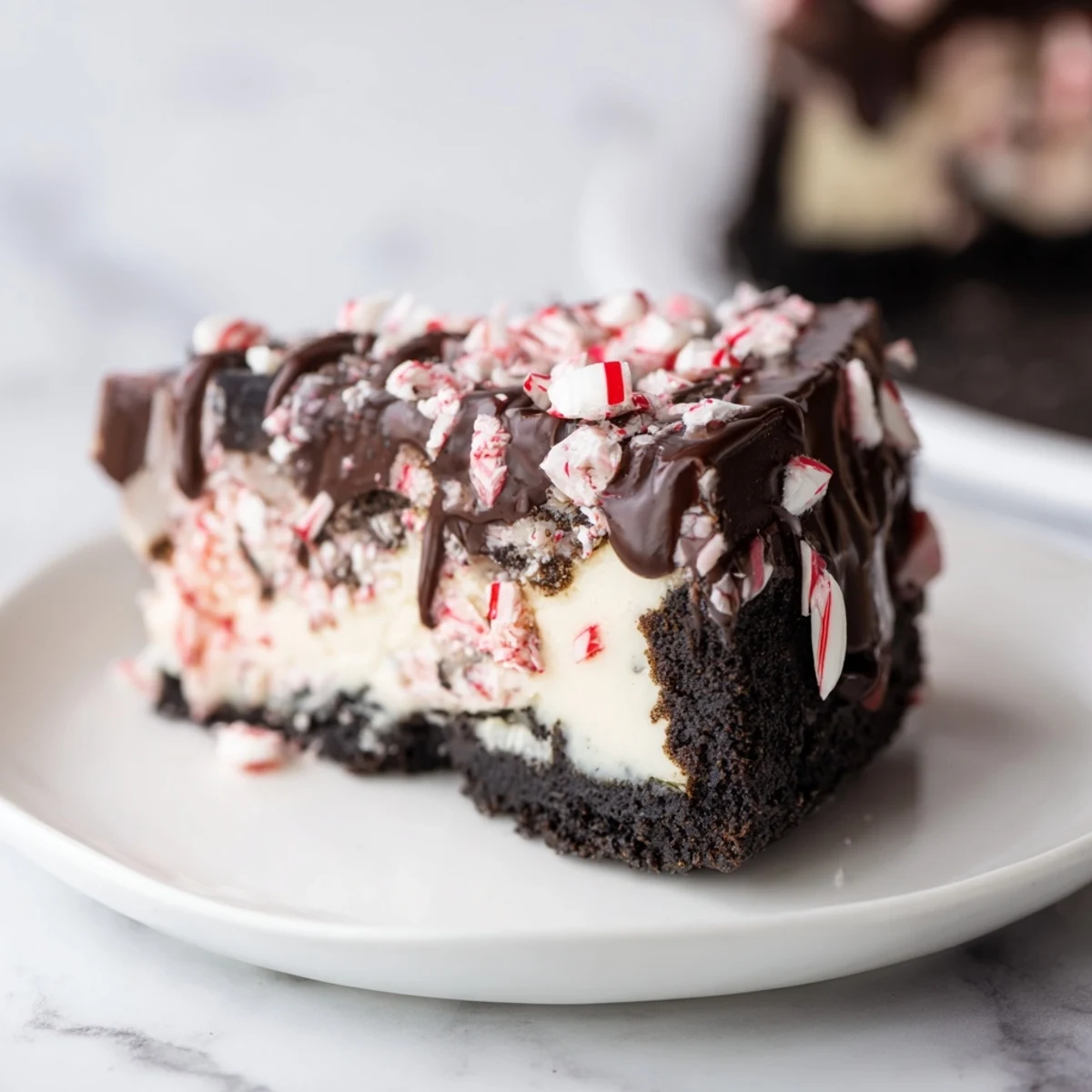 Rich and creamy Peppermint Bark Cheesecake, delightfully topped with crisp, crushed peppermint candy pieces.