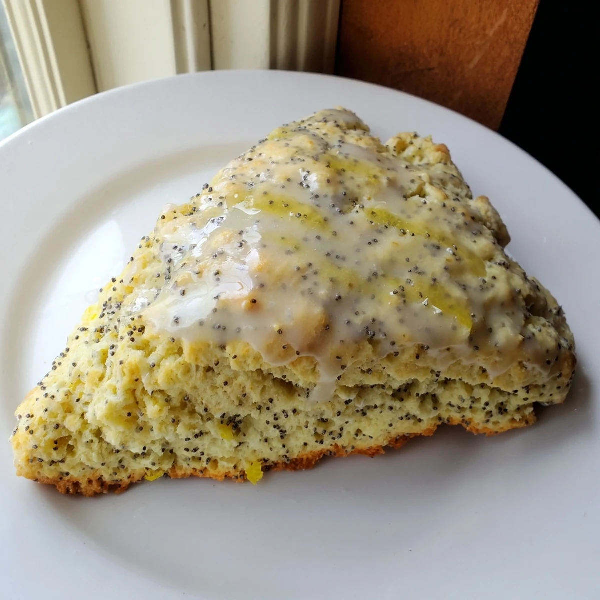 Golden-brown Zesty Lemon and Poppy Seed Scones, served warm and ready to enjoy with breakfast.