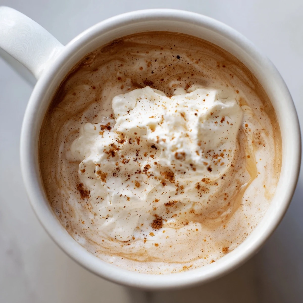 Steaming Spiced Latte with a swirl of cinnamon; the perfect warming beverage to enjoy.