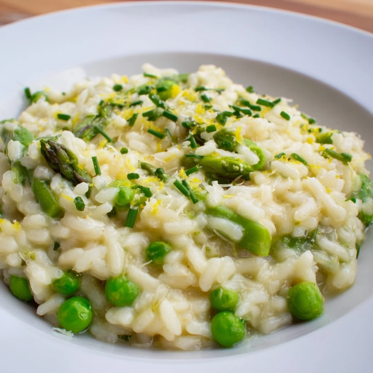 Serve Creamy Spring Pea and Asparagus Risotto as a cozy main dish with crusty bread and extra cheese.