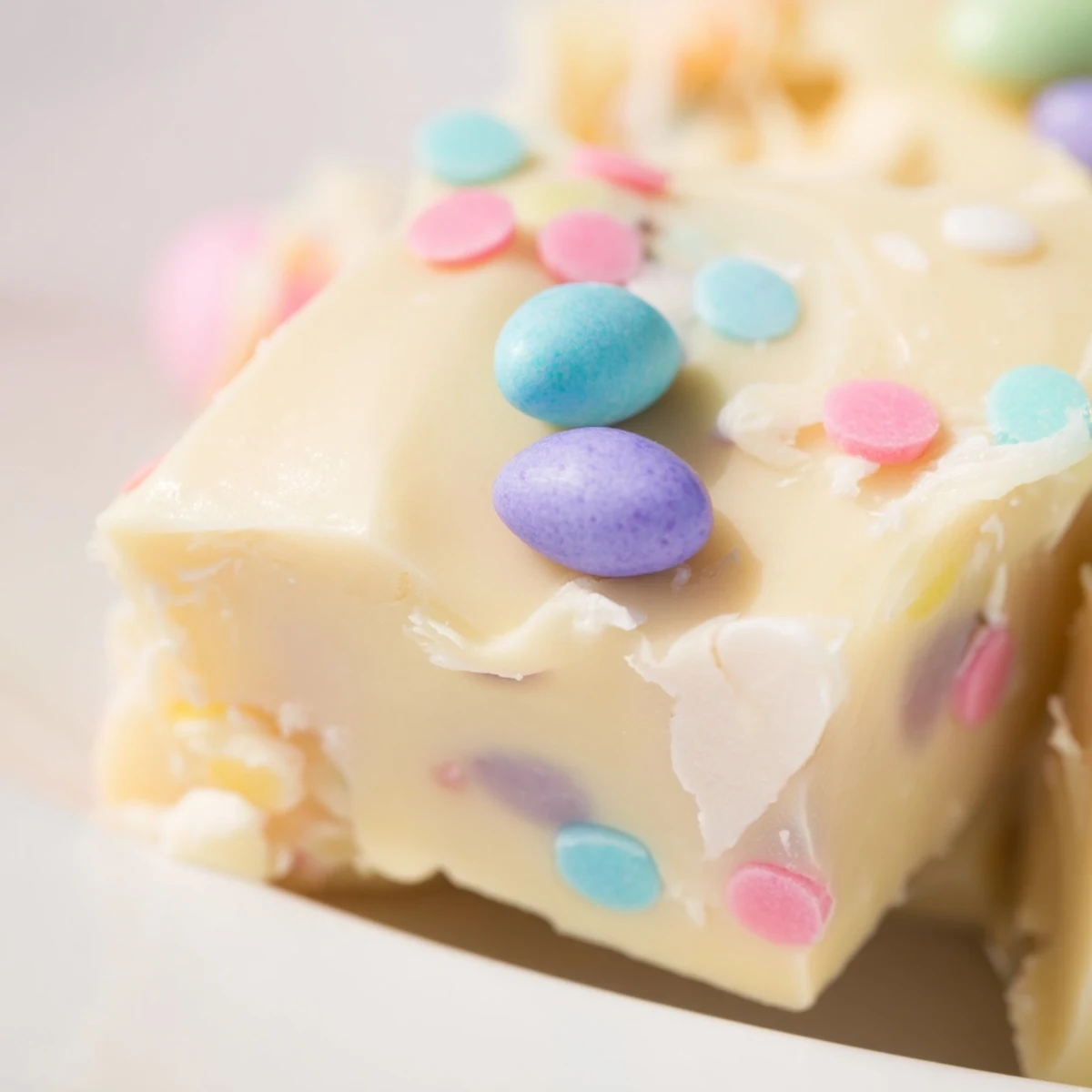 Soft fudge squares topped with colorful candy eggs and sprinkles for a sweet spring treat.