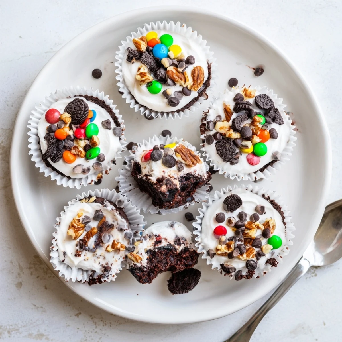 Decadent loaded brownie cheesecake cups showing creamy vanilla filling and crunchy toppings