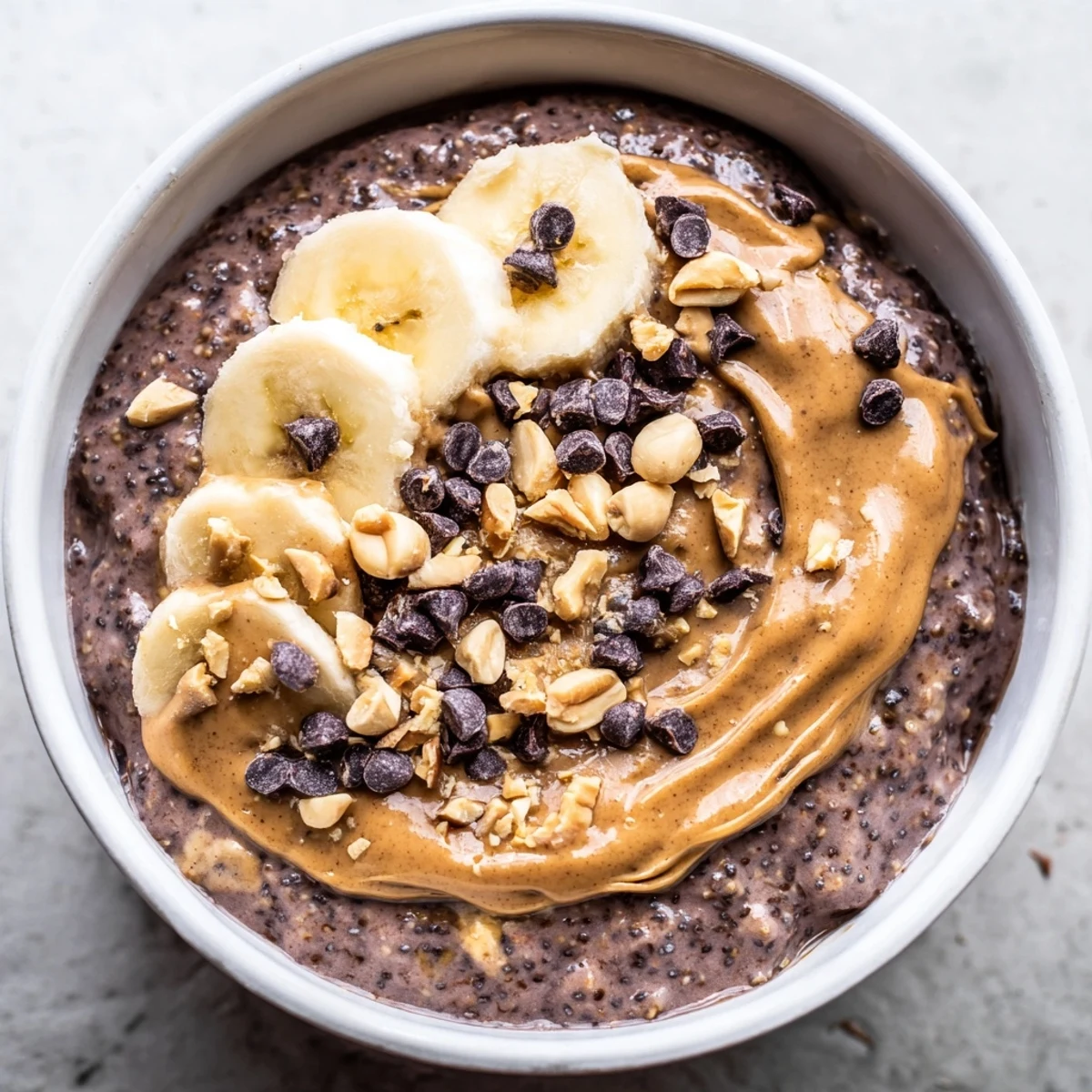 Creamy chocolate peanut butter overnight oats in a mason jar topped with chocolate chips