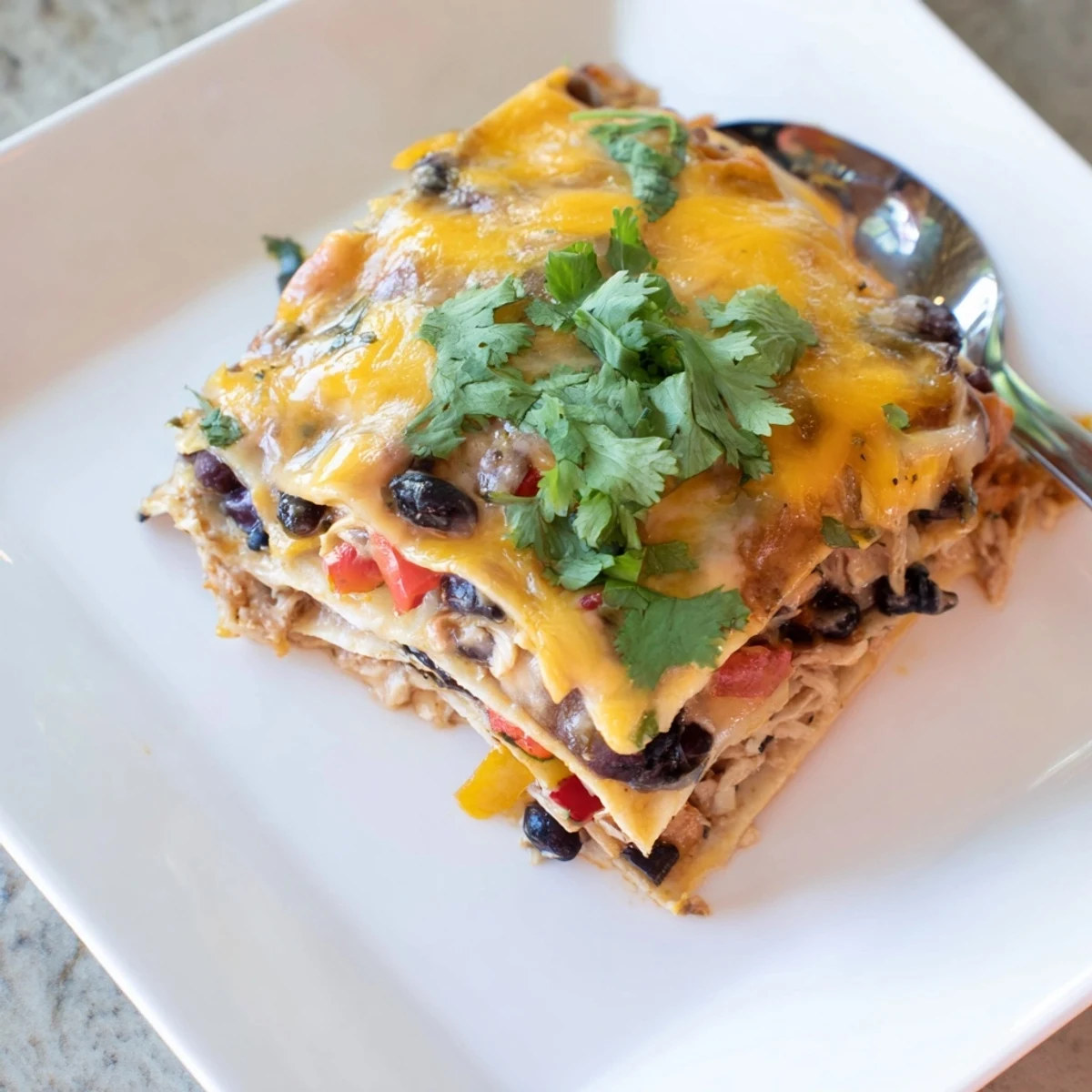 Golden bubbly creamy chicken taco lasagna fresh from oven with melted cheddar